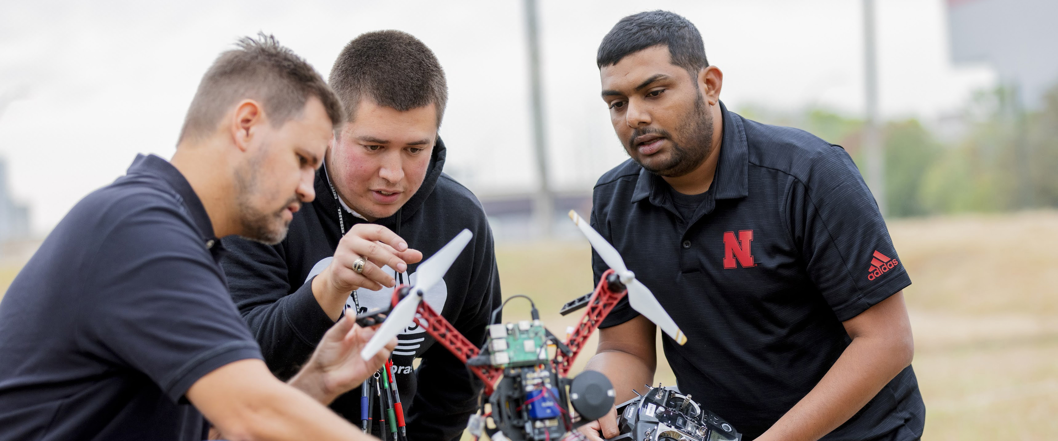 Members of the NIMBUS Lab examining a drone