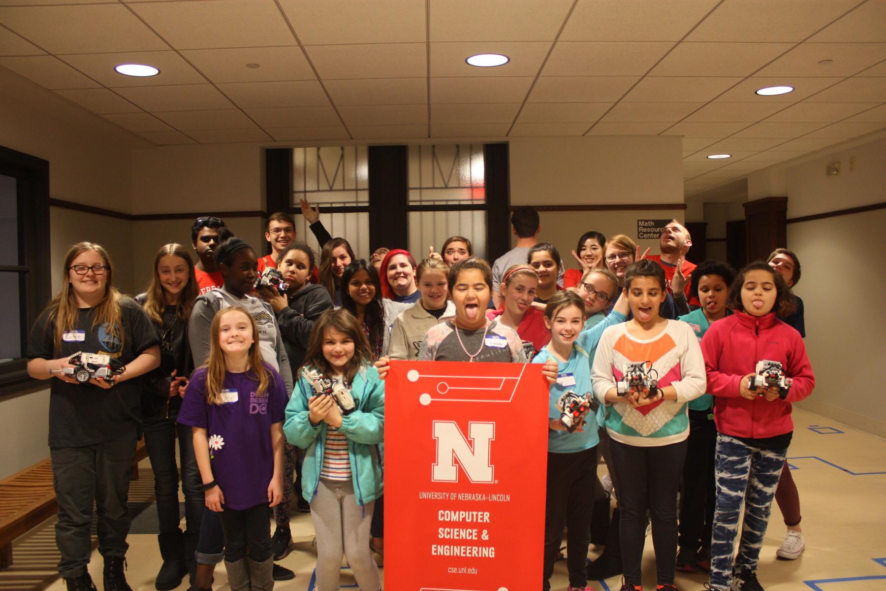 The Girl Scouts and mentors pose for a silly group photo.