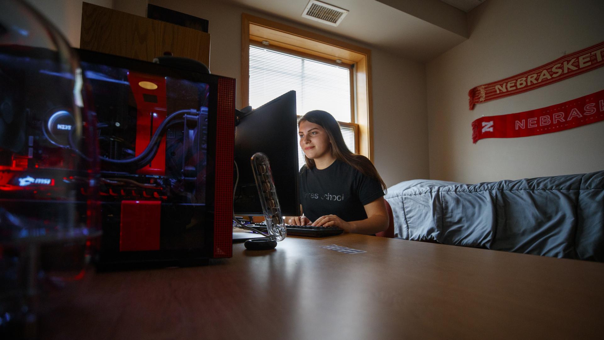 Engineering student looking up with virtual reality equipment.