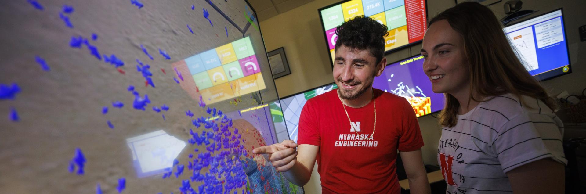 Engineering student looking up with virtual reality equipment.