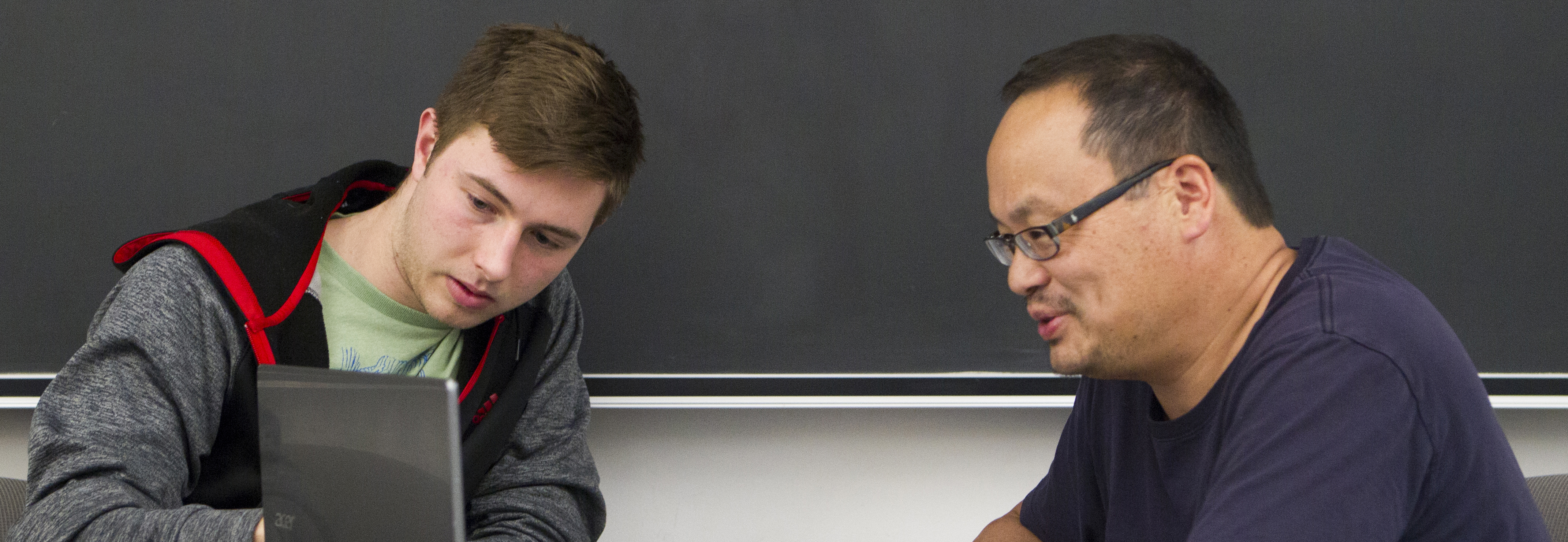 Faculty interacting with a student on an assignment.