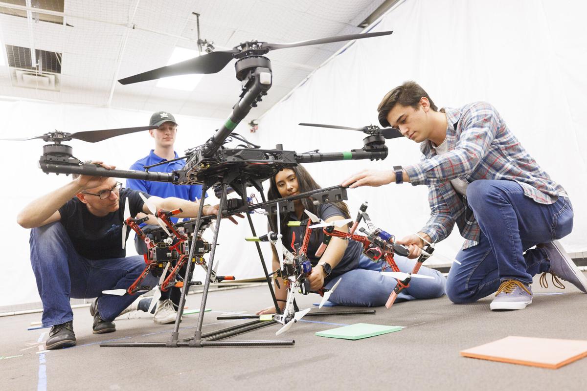 Huskers work on a drone in a College of Engineering lab in 2022. A UNL research team will work to design drones and boats capable of navigating Alaska's difficult terrain.