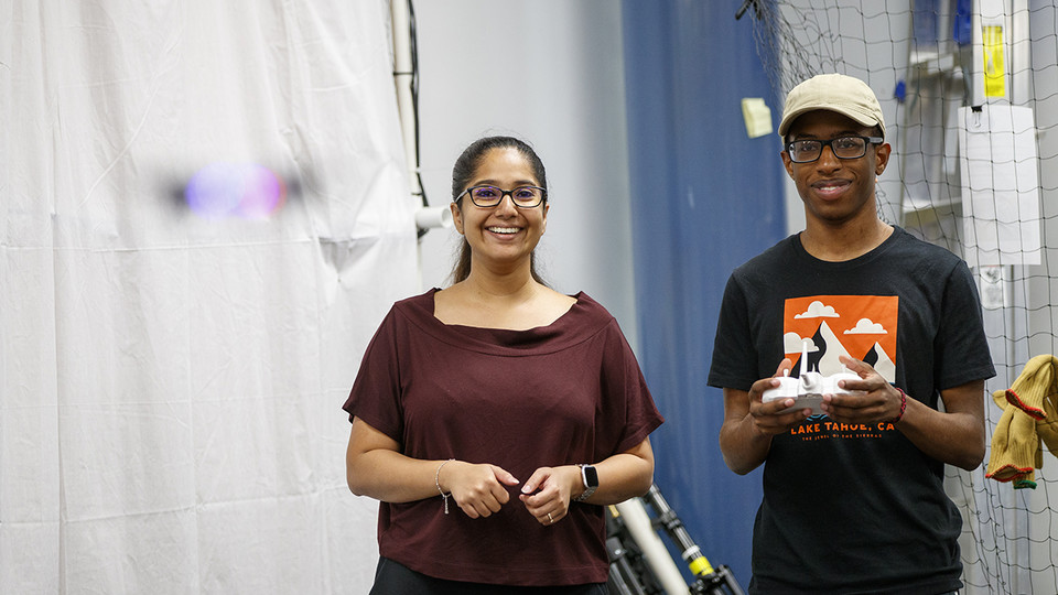 Nathan Simms, a freshman mechanical engineering major from Bellevue, Nebraska, learns how to fly a drone with instruction from doctoral student Siya Kunde.