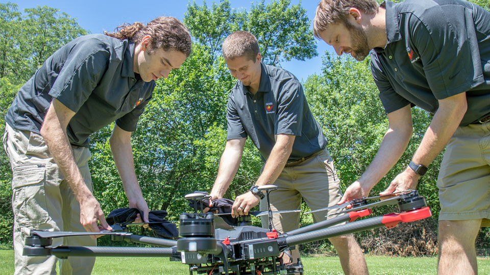 Evan Beachly (from left), Jim Higgins and Carrick Detweiler assemble a drone system before taking it for a test flight. The system features a software application that makes it easy to operate. It can also be flown at night, helping crews safely fight fires despite limited visibility.