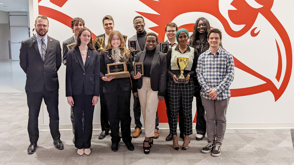 The national champion debate team is (front row, from left) Juliana Quattrocchi, Amber Tanehill, Andromede Uwase, Azza Elhaj, assistant coach Colin Dike, (back row, from left) director Justin Kirk, Zachary Wallenburg, Nicholas Wallenburg, Salman Djingueinabaye, Gregory Quick and Omaima Lado.