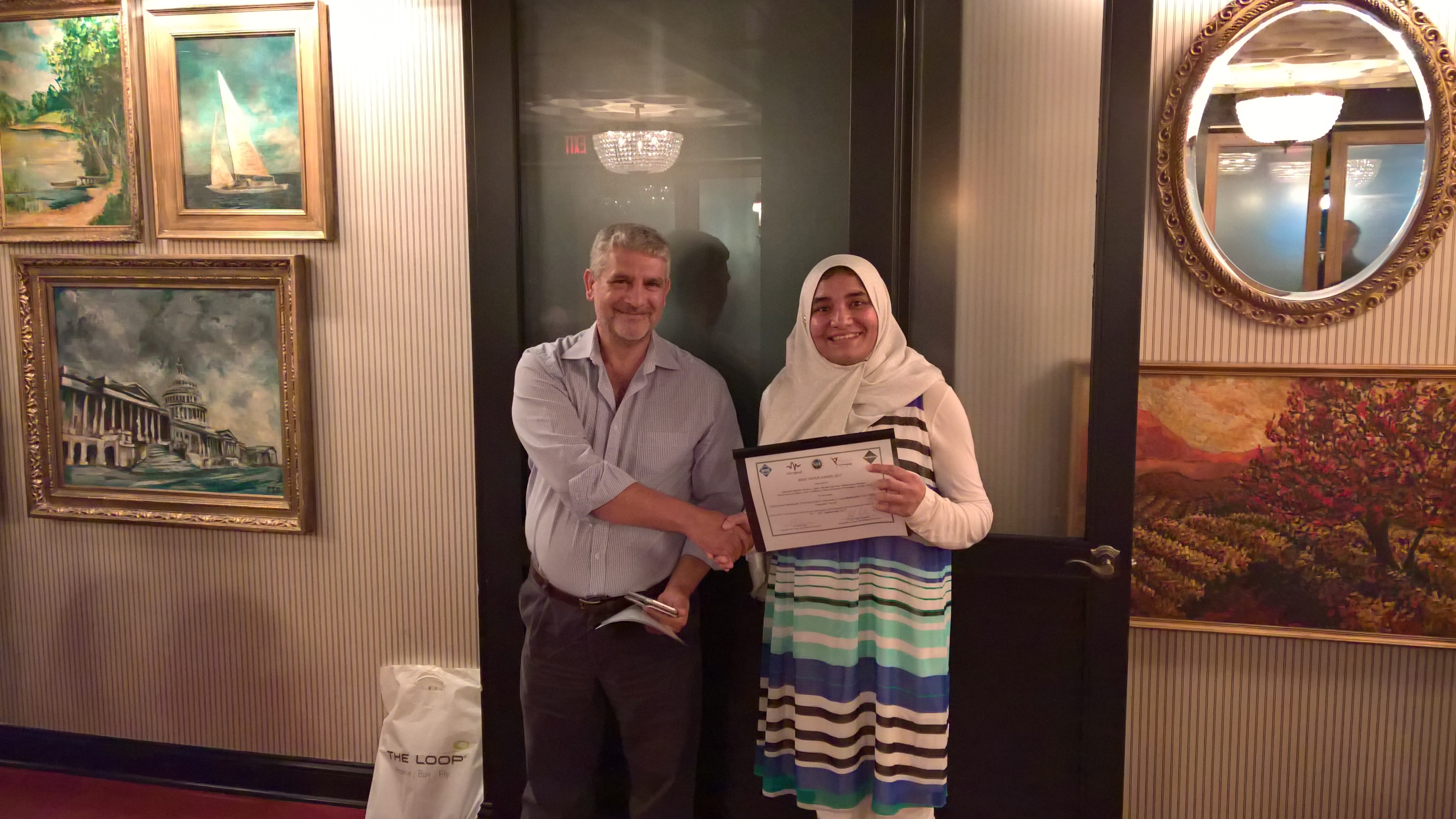 Graduate student Zahmeeth Sakkaff accepts the ACM NanoCom Best Paper Award. 