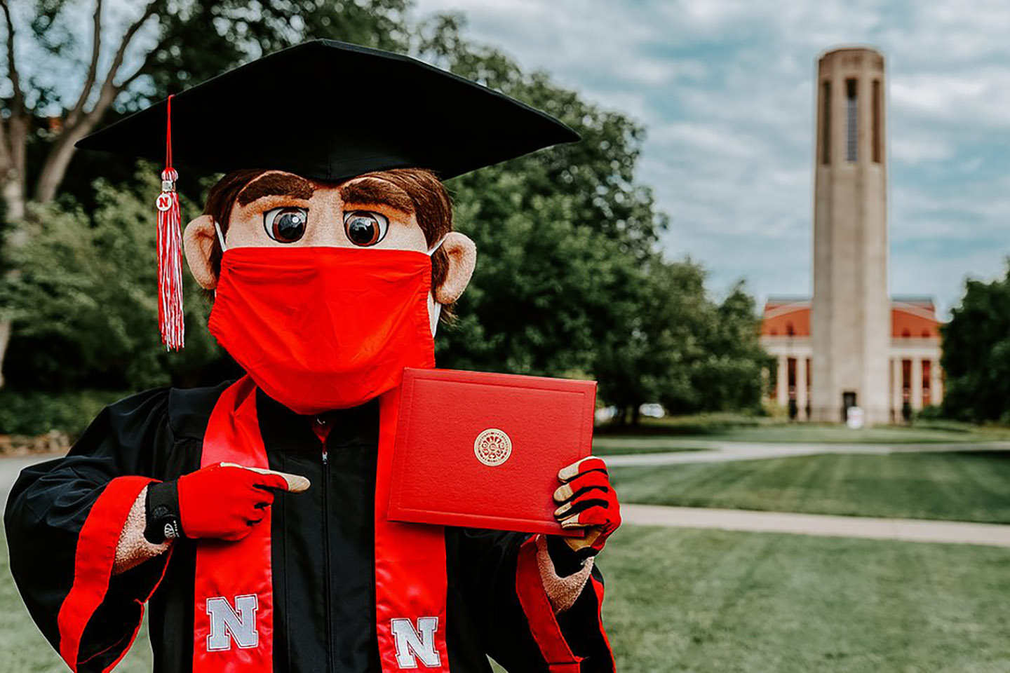 Mascot Herbie Husker with his diploma.