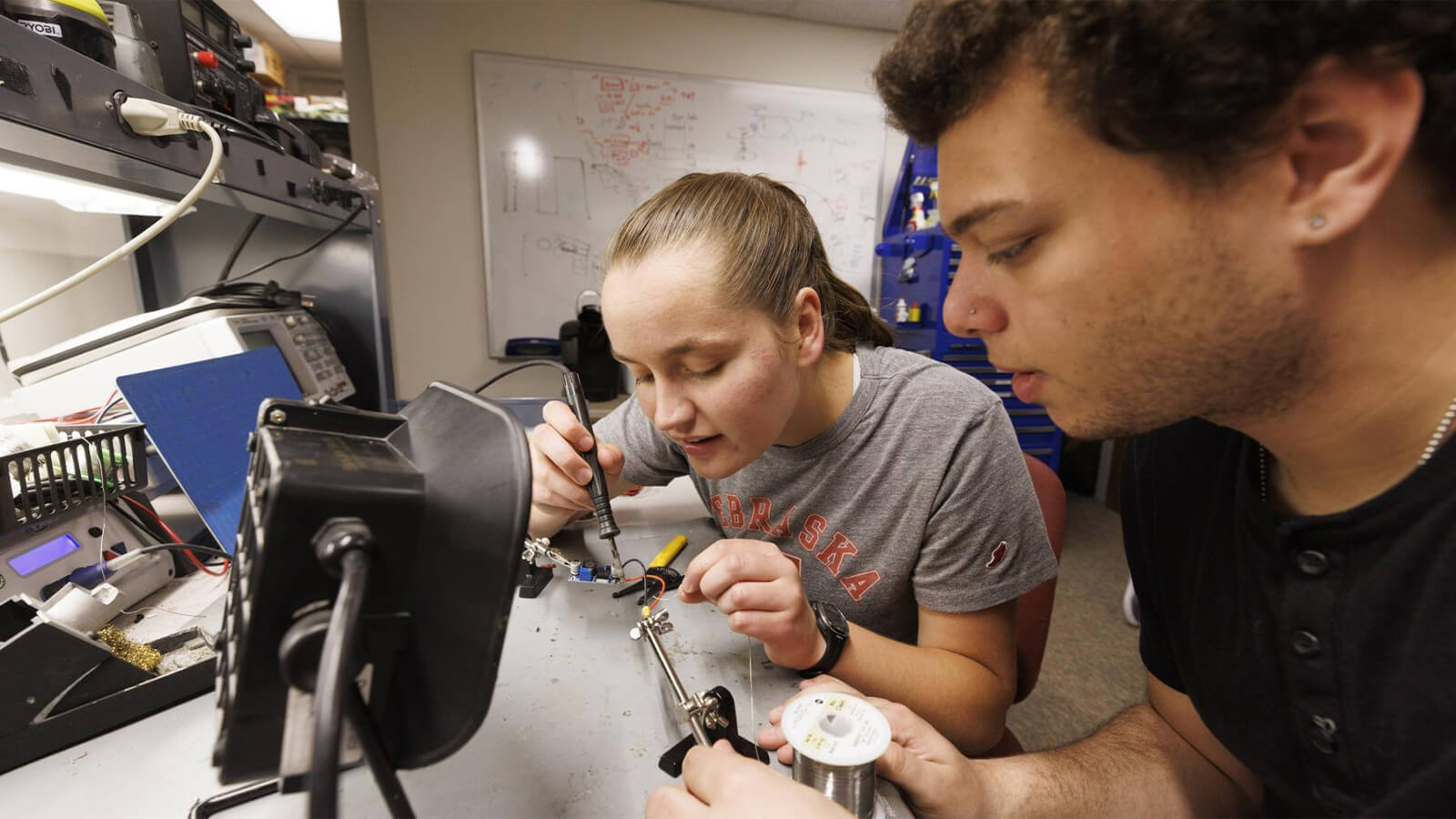 Students working together on soldering a project