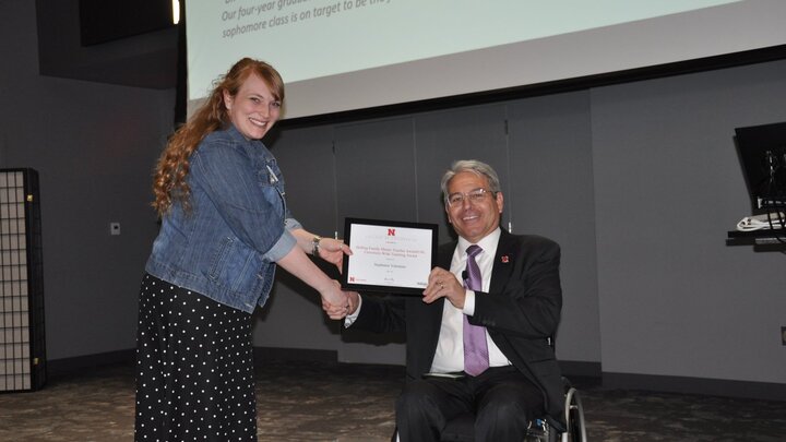 Stephanie Valentine accepts her award from College of Engineering Dean Lance Perez at the 2022 Employee Awards ceremony on April 8.