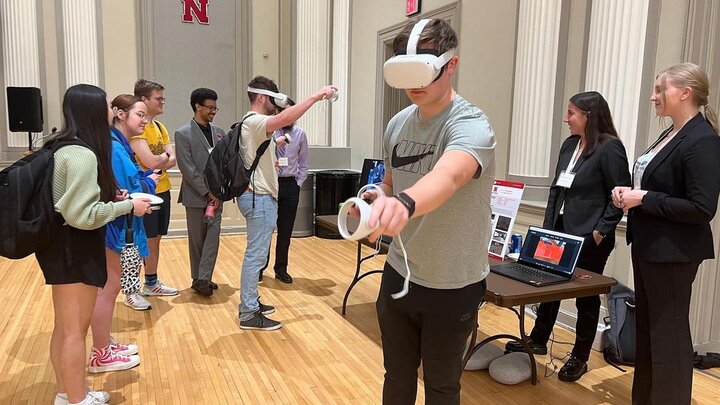 Students present and test a VR project at the 2023 Senior Design Showcase in May.