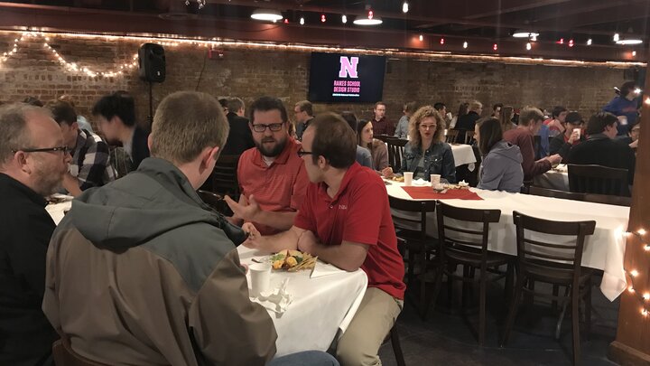 Student enjoying dinner at the Talon Room during the Senior Design and Design Studio Awards Reception.