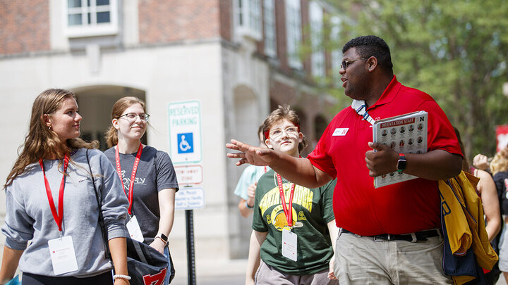 Orientation leader Jayven Brandt shares his experiences as a Husker with incoming freshmen outside the Nebraska Union in June 2021.