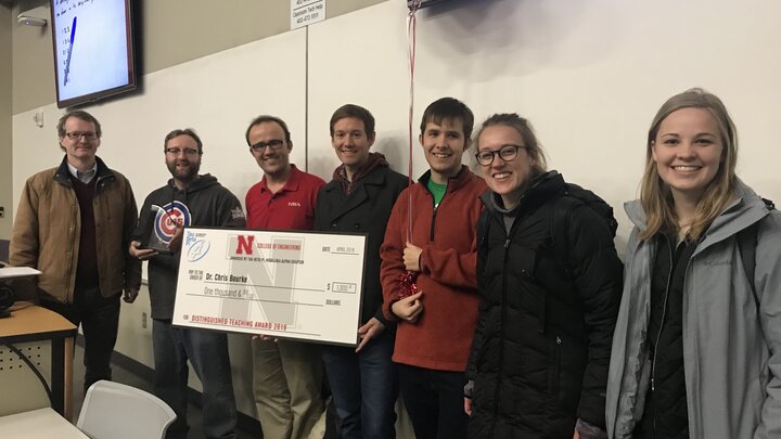 Department chair Matthew Dwyer and members of Tau Beta Pi presenting Chris Bourke with the 2018 Tau Beta Pi Distinguished Teaching Award on Tuesday during class in Brace Hall.