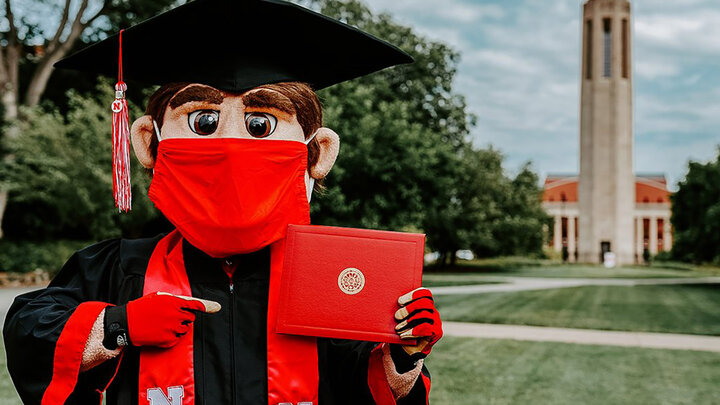 Mascot Herbie Husker with his diploma.