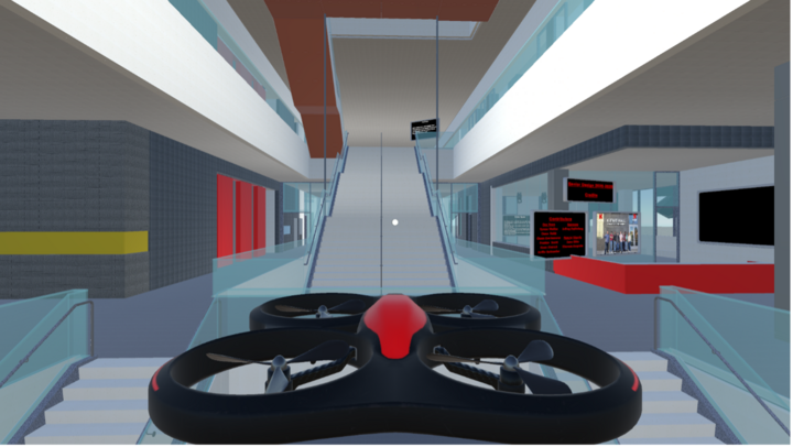 A drone hovering indoors near the main staircase in Kiewit Hall.